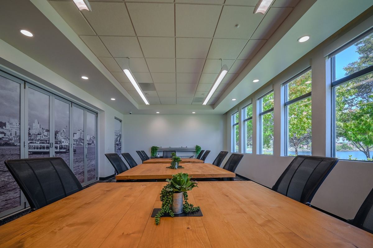 The boardroom: a long timber table under a wall of windows onto the bay