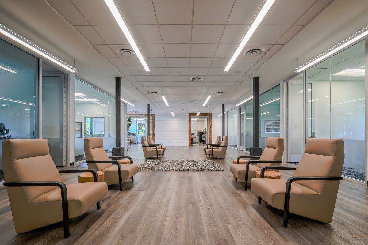 The lounge: leather chairs along a light-filled corridor of glass-fronted suites